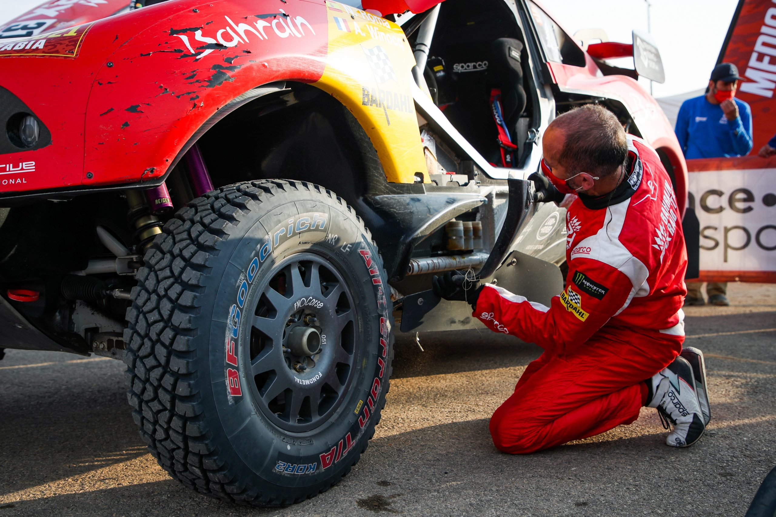Co-driver Alexandre Winocq works to install a 3D printed bracket to hold an on-board sensor in-place. Critical for providing real-time race data back to the engineers.